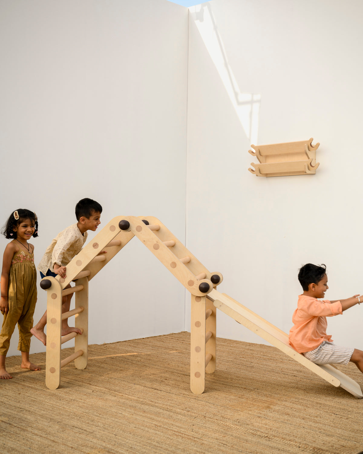 Children playing on the Transformable Pikler jungle gym