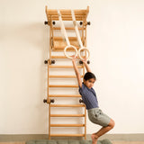 Keya playing on the transformable Pikler jungle gym with gymnastics rings