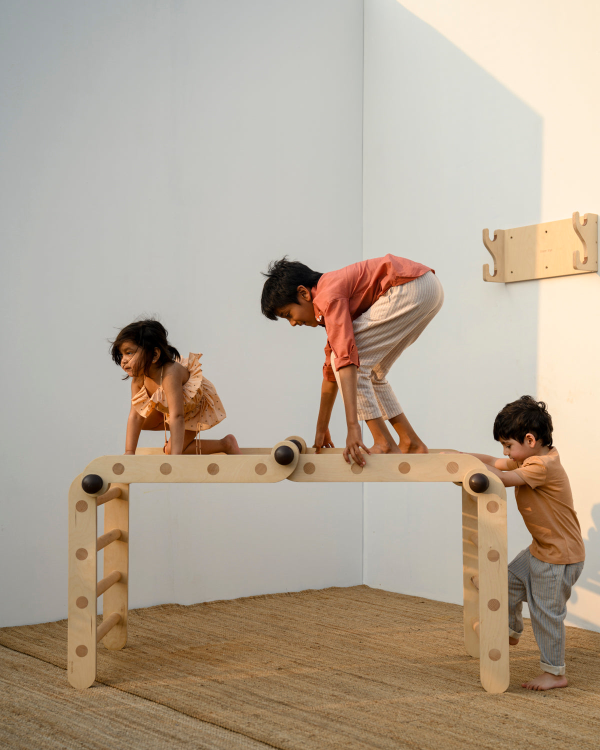 Multiple children on the Transformable Pikler jungle gym