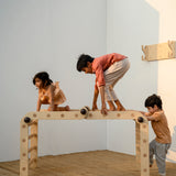 Multiple children on the Transformable Pikler jungle gym