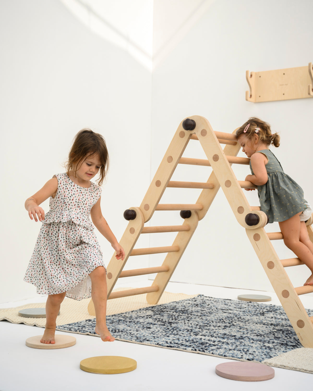 kids playing on the transformable pikler jungle gym