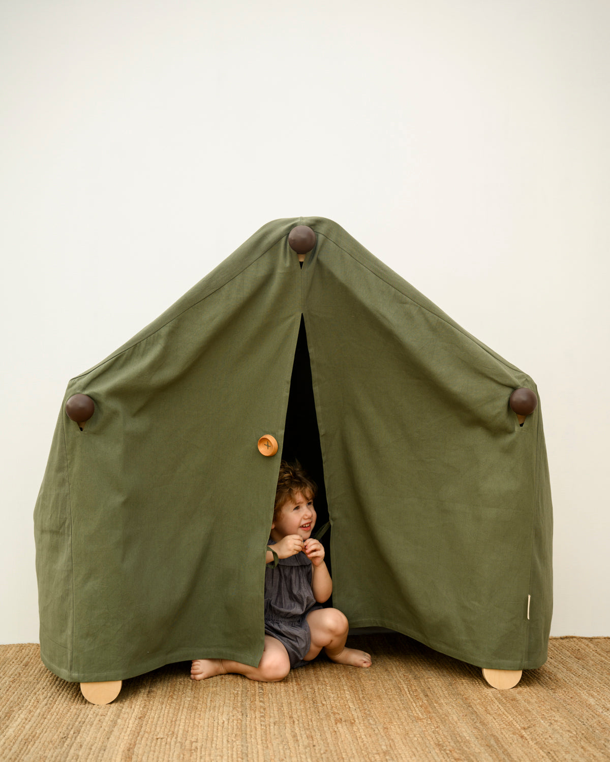 Transformable Pikler jungle gym being used as a tent house for kids