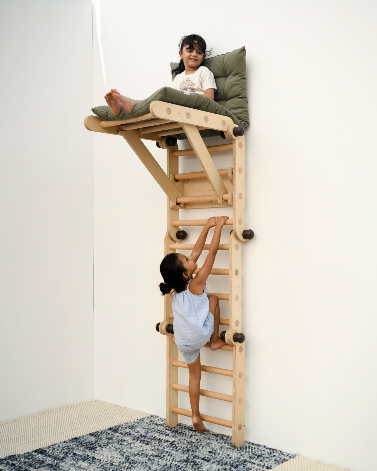 kids playing on transformable pikler jungle gym in wall mount position